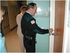 Police officer unlocking a door